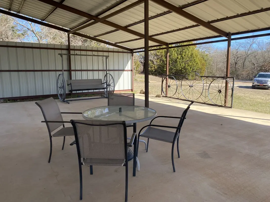 covered concrete pad with patio furniture